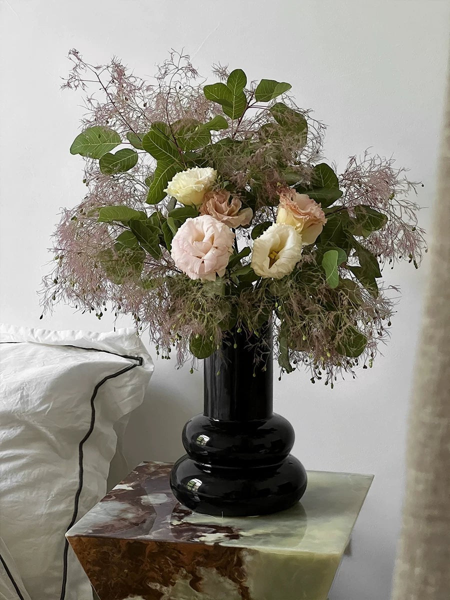 Cosik Home original black gourd ceramic vase with stacked spherical base, holding a floral arrangement.