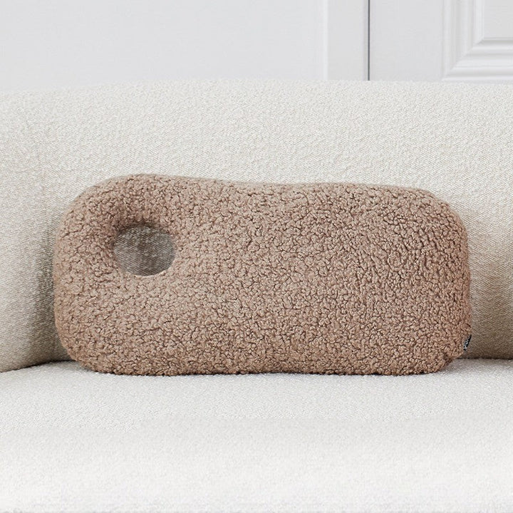 Cosik Home abstract bouclé donut throw pillow in taupe, featuring an organic shape with an off-center cutout.