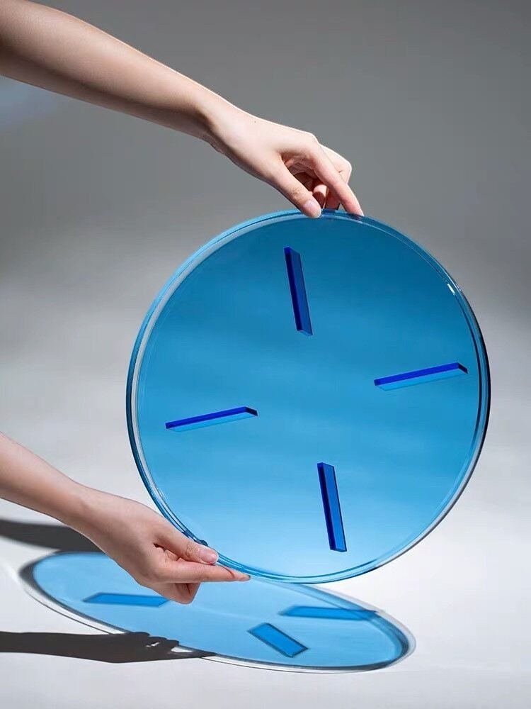 Cosik Home blue transparent acrylic circular display tray with geometric raised base for modern décor.