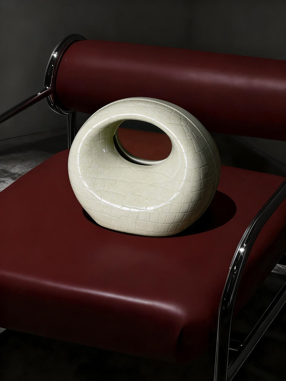 Cosik Home Crescent Tissue Holder in cream ceramic with a textured finish, featuring a circular opening.