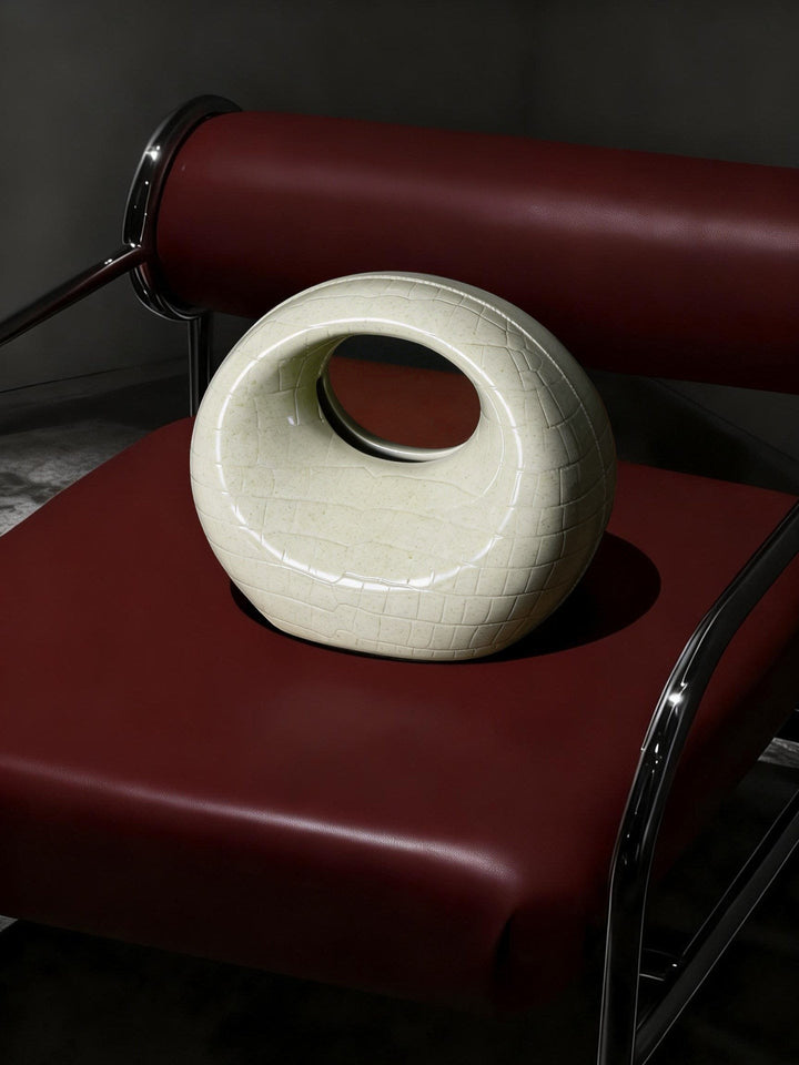 Cosik Home Crescent Tissue Holder in cream ceramic with a textured finish, featuring a circular opening.