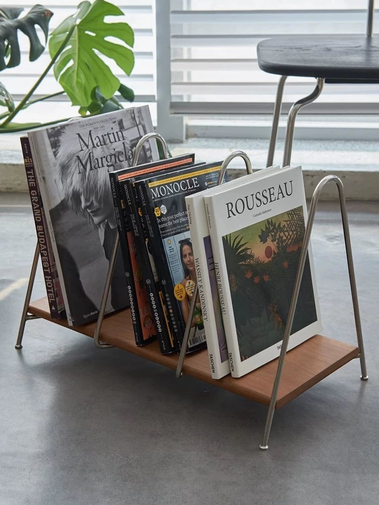 Cosik Home modern magazine rack with minimalist metal frame and wood base, holding several books and magazines.