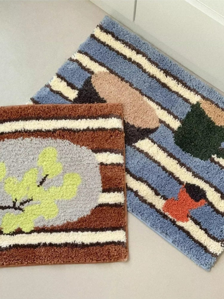 Cosik Home retro tufted plush bath mat with abstract leaf and stripe pattern in blue, brown, and cream.