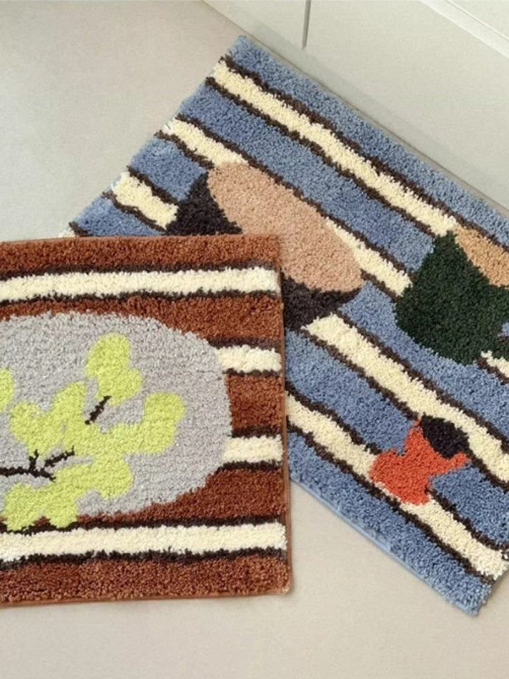 Cosik Home retro tufted plush bath mat with abstract leaf and stripe pattern in blue, brown, and cream.