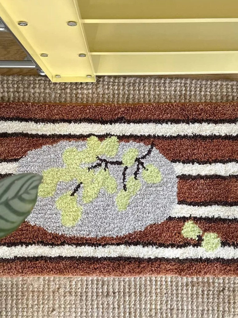 Cosik Home retro tufted plush bath mat with brown, white, and grey stripes and a light green leaf design.