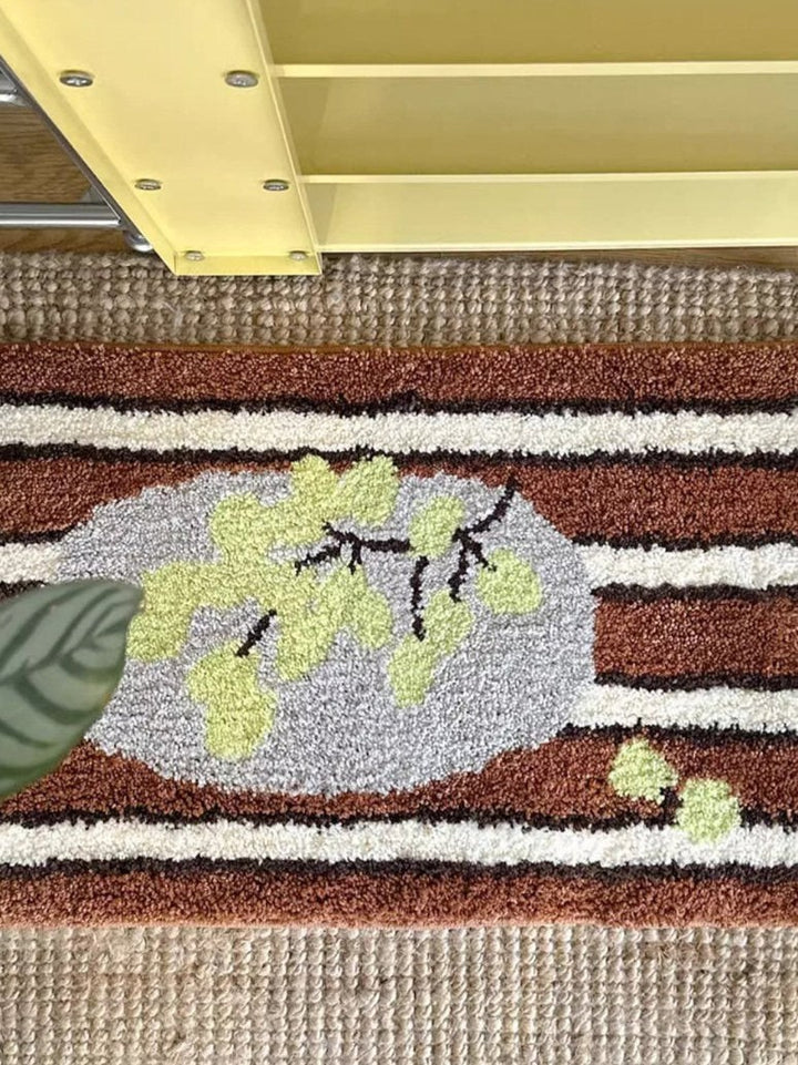 Cosik Home retro tufted plush bath mat with brown, white, and grey stripes and a light green leaf design.