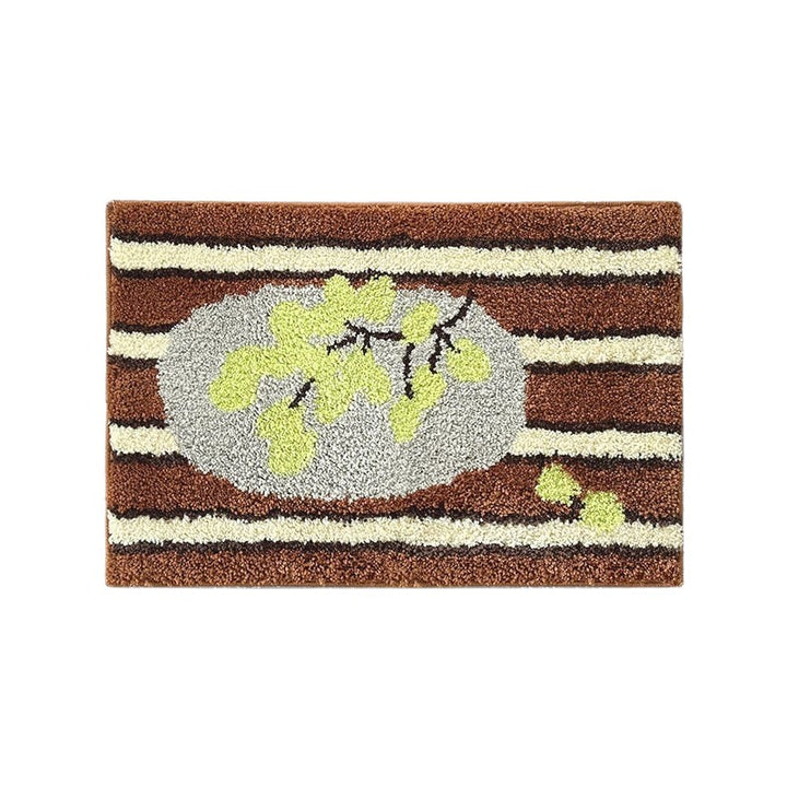 Cosik Home retro tufted plush bath mat with brown and cream stripes and a grey oval with green leaves.