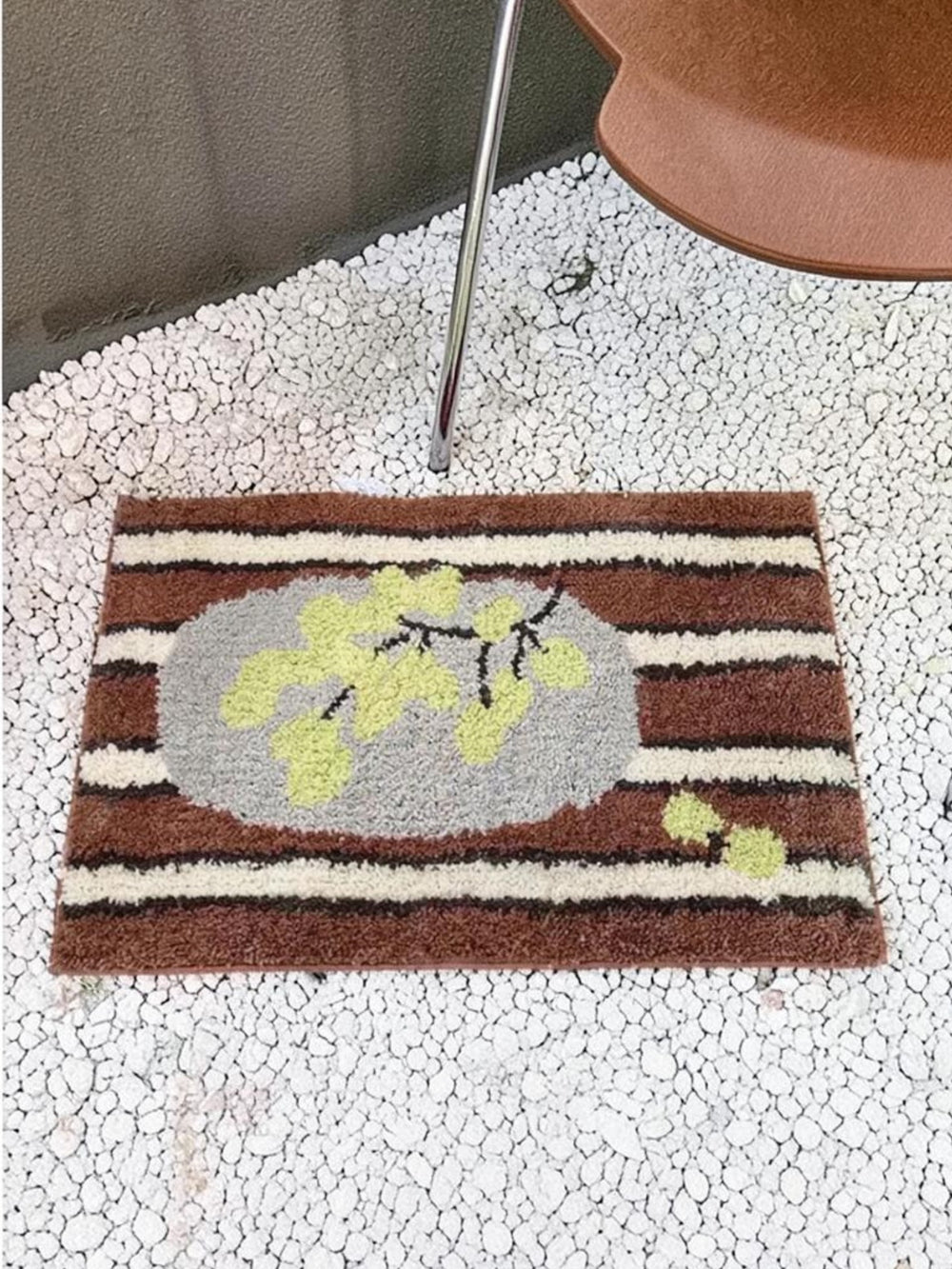 Cosik Home retro tufted plush bath mat with brown, white, and grey stripes and a light green floral design.