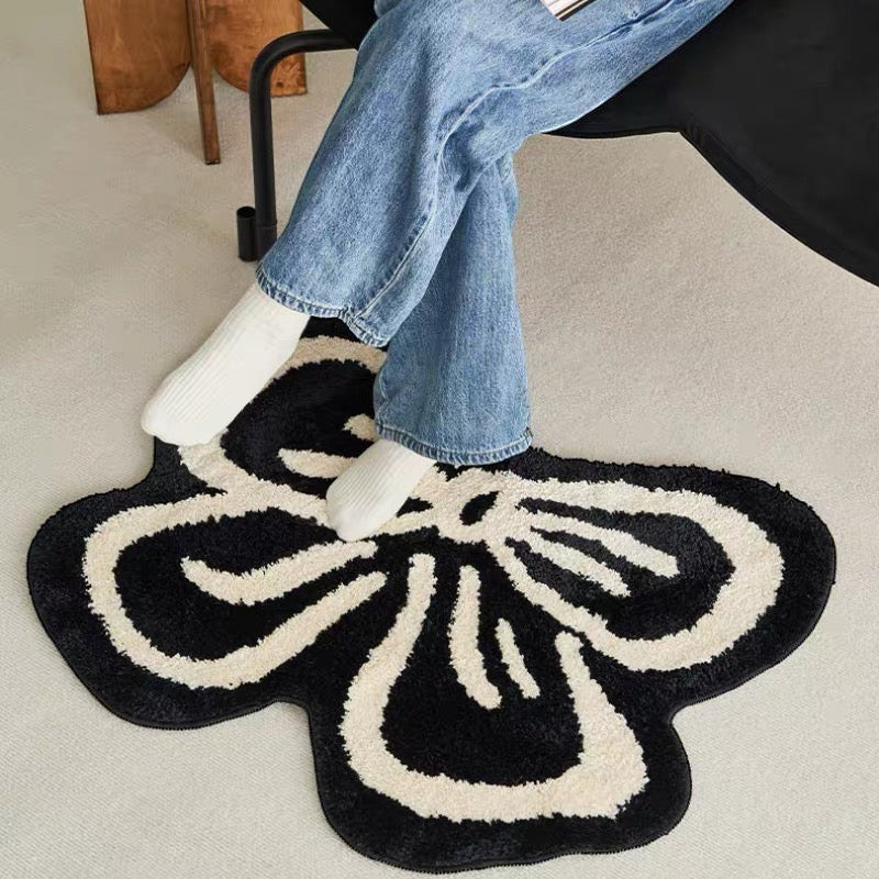 Cosik Home black and cream ribbon bow rug with medium pile. Playful accent for bedroom or bathroom.