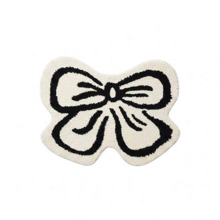 Cosik Home cream and black ribbon bow rug, soft medium pile, playful accent for bedroom or bathroom.